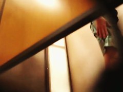 A bodibuilder woman is not aware that a hidden dressing room camera is spying after her