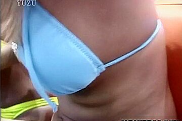 Beautiful Asian babes in bikini give a double blowjob in a public place!