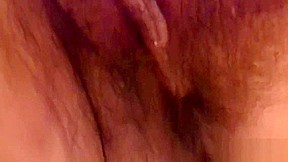 Big titted slut rubbing her hairy cunt
