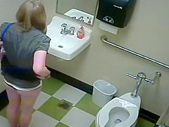 Blonde girl in pees in a public toilet