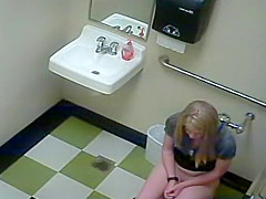 Blonde girl in pees in a public toilet