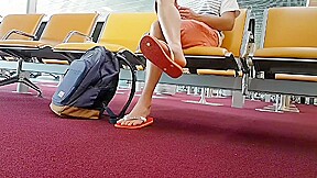 Boy put on flip flops and anklet in airport