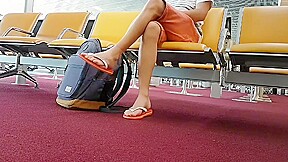 Boy put on flip flops and anklet in airport