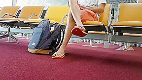 Boy put on flip flops and anklet in airport