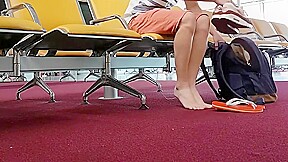 Boy put on flip flops and anklet in airport