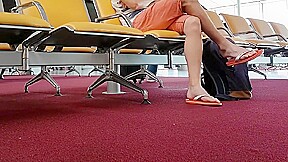 Boy put on flip flops and anklet in airport