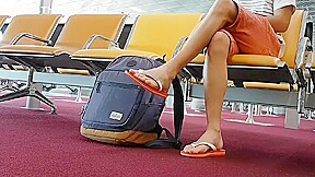 Boy put on flip flops and anklet in airport