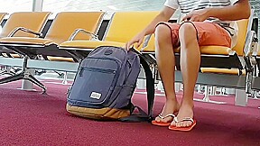 Boy put on flip flops and anklet in airport