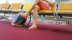 Boy put on flip flops and anklet in airport