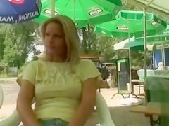 Busty blonde posing when fingering the pussy in public