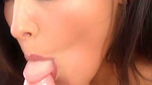 Busty brunette sucking cock