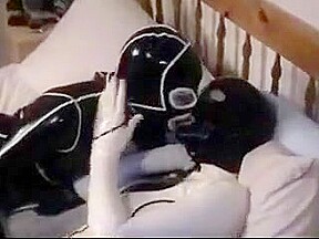 Cute college girl making out in latex catsuits