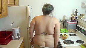 Fattened wife in kitchen