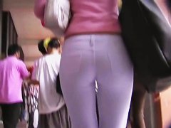 Fit brunette in white skintight pants walks in a student 18+ hall candid porn