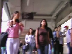 Fit brunette in white skintight pants walks in a student 18+ hall candid porn
