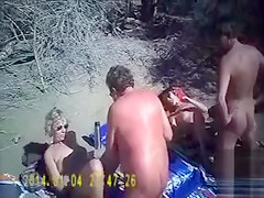 French swingers fuck on the nude beach as people watch
