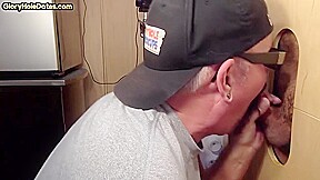 Gloryhole inked BJ DILF sucks BFs cock through hole at home