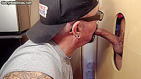 Gloryhole inked BJ DILF sucks BFs cock through hole at home