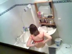 Gorgeous brunette getting ready to take hidden shower