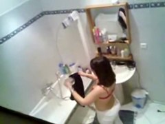 Gorgeous brunette getting ready to take hidden shower