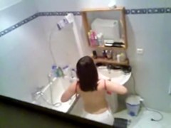 Gorgeous brunette getting ready to take hidden shower