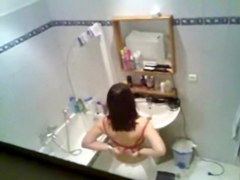 Gorgeous brunette getting ready to take hidden shower