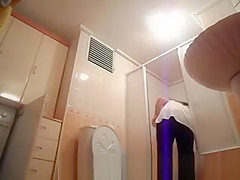 Hot busty woman undressing before shower