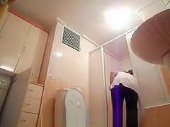 Hot busty woman undressing before shower
