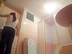 Hot busty woman undressing before shower