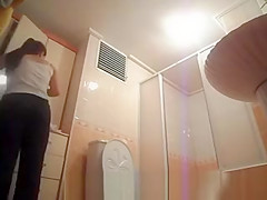 Hot busty woman undressing before shower