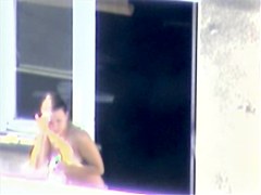 Nude titted minx caught on cam on the balcony