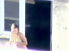 Nude titted minx caught on cam on the balcony