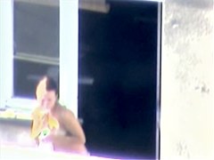 Nude titted minx caught on cam on the balcony