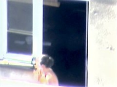 Nude titted minx caught on cam on the balcony
