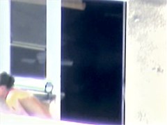 Nude titted minx caught on cam on the balcony