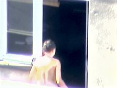 Nude titted minx caught on cam on the balcony