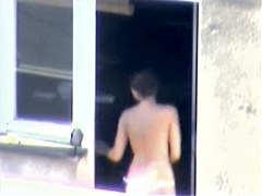 Nude titted minx caught on cam on the balcony