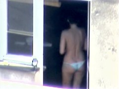 Nude titted minx caught on cam on the balcony