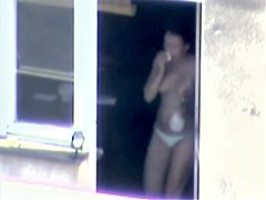 Nude titted minx caught on cam on the balcony