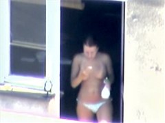 Nude titted minx caught on cam on the balcony