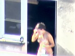 Nude titted minx caught on cam on the balcony