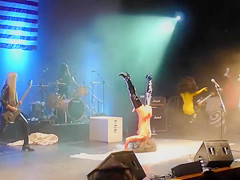 Painted boobs bounce around on the stage at a rock concert
