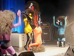 Painted boobs bounce around on the stage at a rock concert