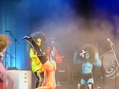 Painted boobs bounce around on the stage at a rock concert