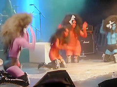 Painted boobs bounce around on the stage at a rock concert