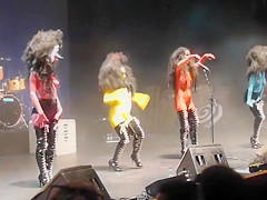 Painted boobs bounce around on the stage at a rock concert