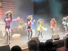 Painted boobs bounce around on the stage at a rock concert