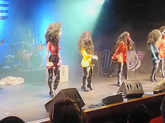 Painted boobs bounce around on the stage at a rock concert