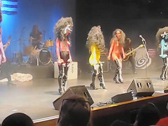 Painted boobs bounce around on the stage at a rock concert