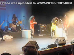 Painted boobs bounce around on the stage at a rock concert